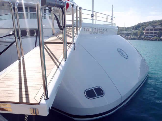 The passerelle rotates starboard in a Jack-Knife movement and stows behind the transom hatch . When the hatch is closed the name of the vessel is visible.
