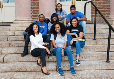 Hampton university students sitting on campus steps